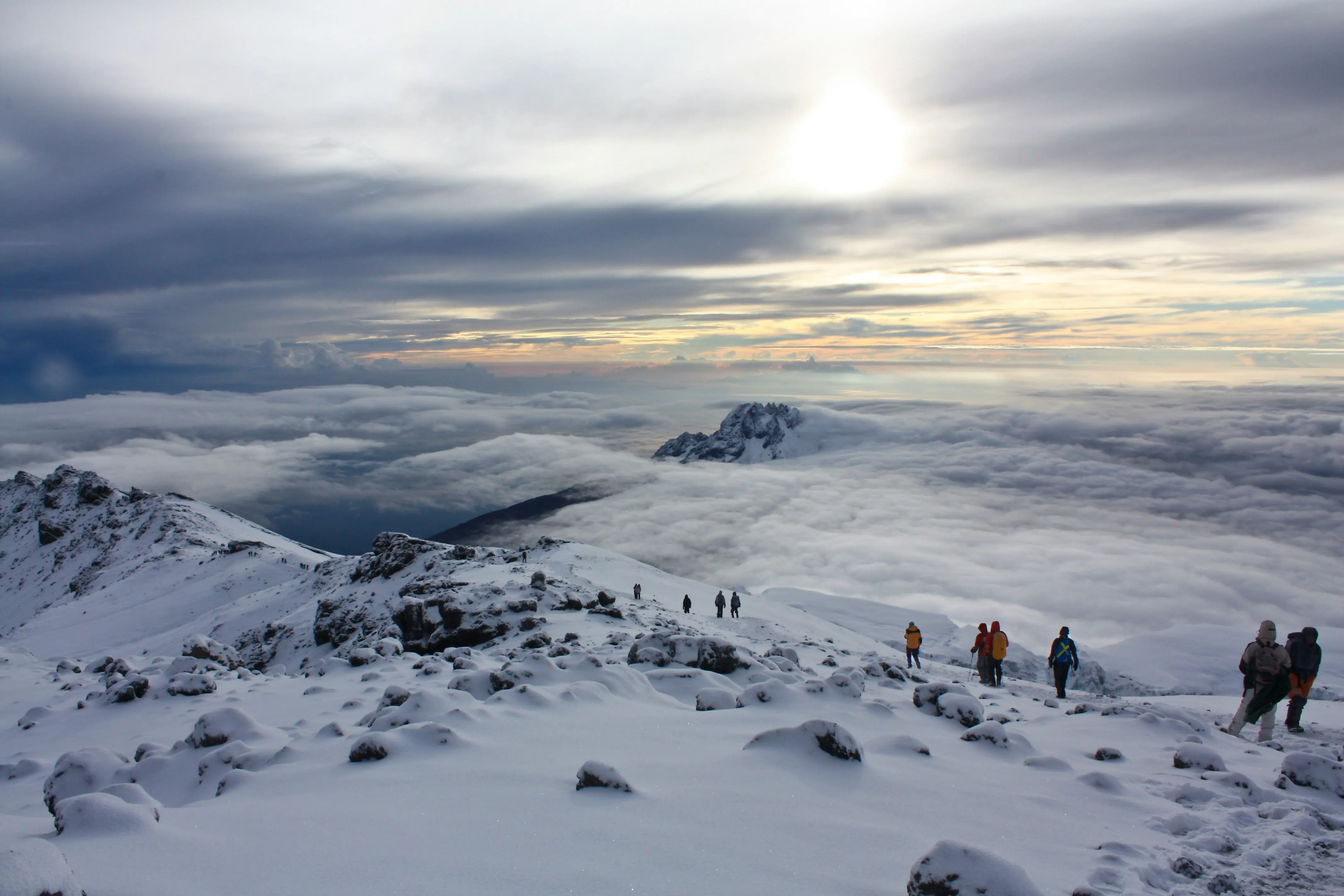 Kilimanjaro climbers ascending above the cloud line toward the summit